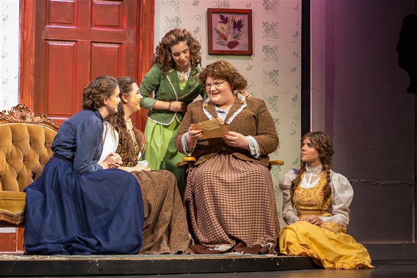 A group of students act onstage